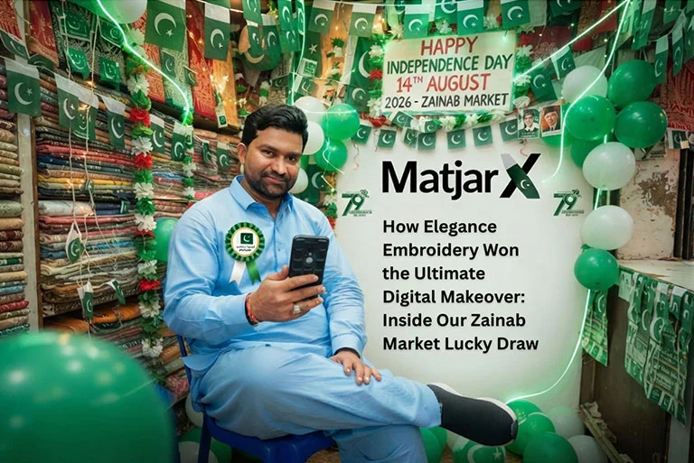 A shop owner sitting inside a Zainab Market shop decorated with Pakistani flags and balloons for Independence Day, holding a phone with the MatjarX logo and title text displayed beside him.